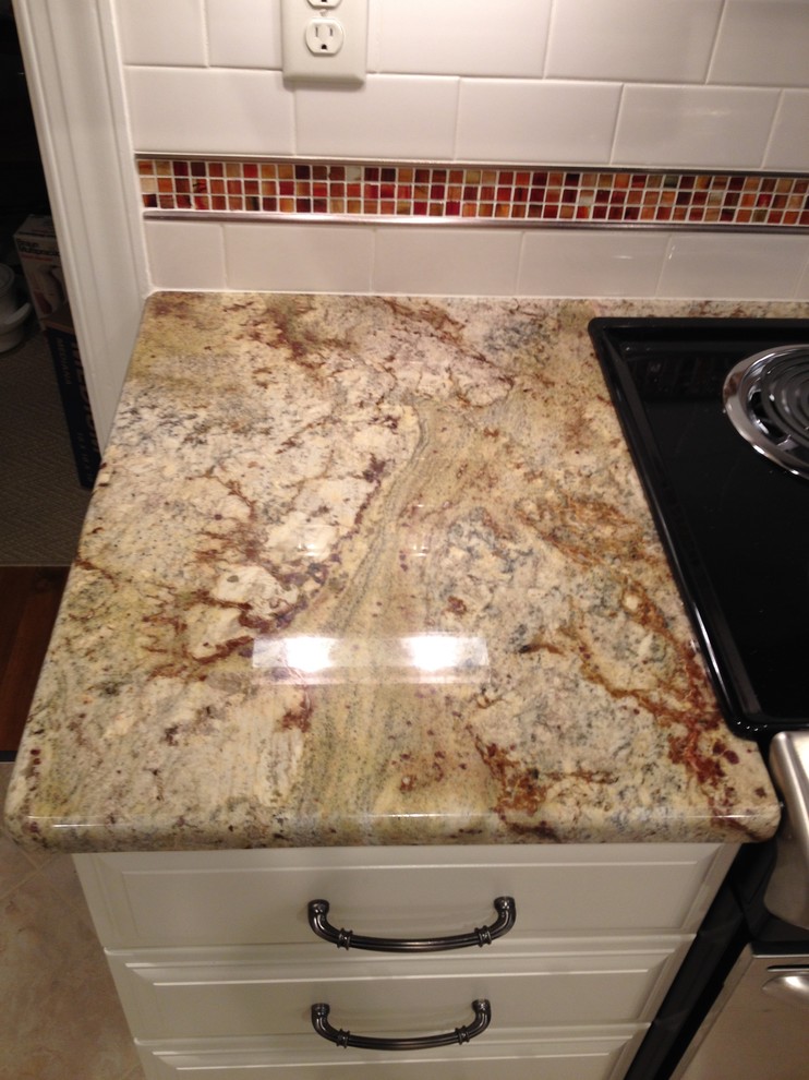 Example of a mid-sized transitional u-shaped ceramic tile eat-in kitchen design in Richmond with an undermount sink, raised-panel cabinets, white cabinets, granite countertops, white backsplash, subway tile backsplash, stainless steel appliances and a peninsula