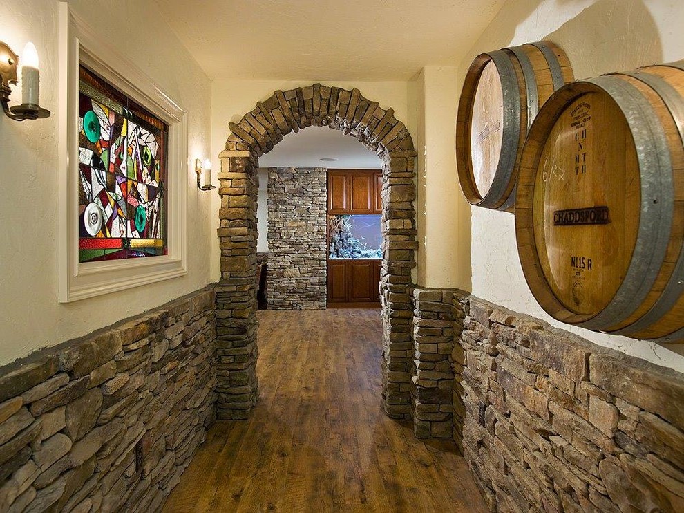 This is an example of a mid-sized country wine cellar in Philadelphia with medium hardwood floors and display racks.