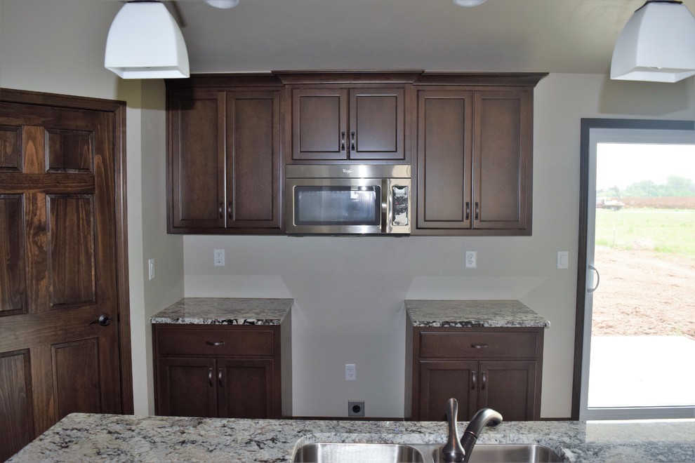 Inspiration for a rustic home design remodel with white cabinets, stainless steel appliances and an island