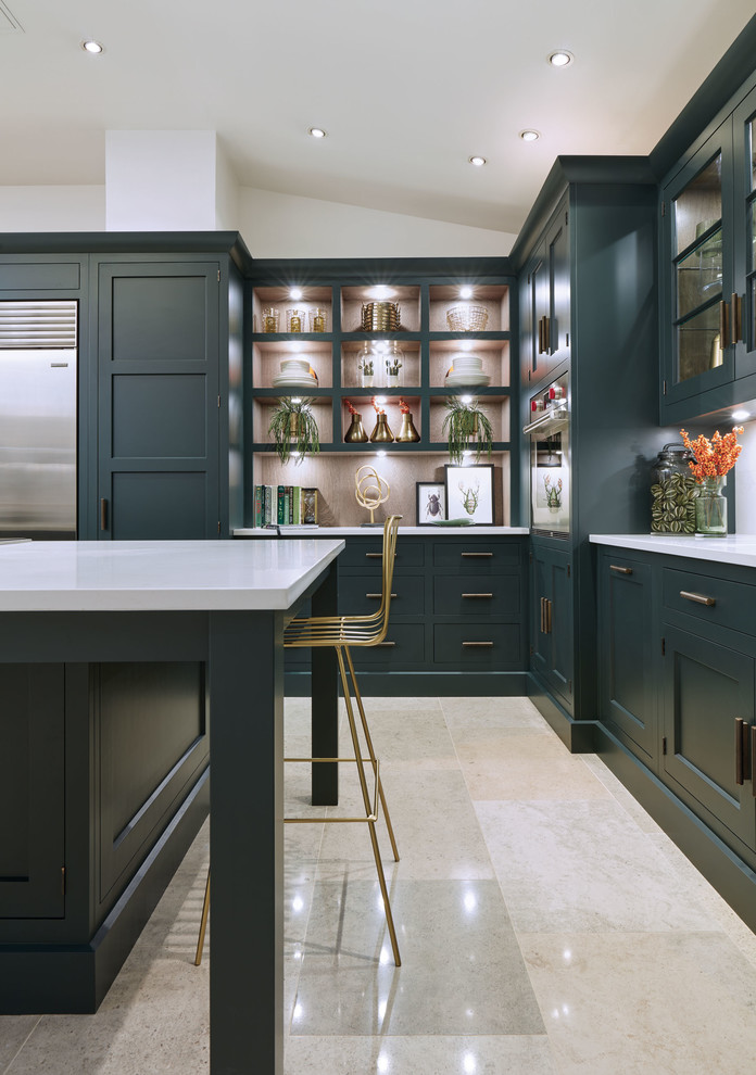 Mid-sized transitional l-shaped eat-in kitchen in London with a drop-in sink, shaker cabinets, green cabinets, quartzite benchtops, white splashback, stainless steel appliances, marble floors, with island, beige floor and white benchtop.