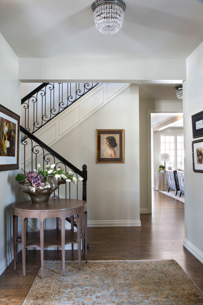 Inspiration for a mid-sized transitional medium tone wood floor and brown floor vestibule remodel in Denver with white walls