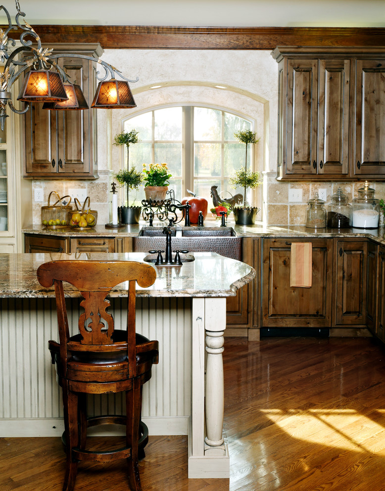 Inspiration for a transitional medium tone wood floor kitchen remodel in Indianapolis with a drop-in sink, medium tone wood cabinets, granite countertops, beige backsplash and an island