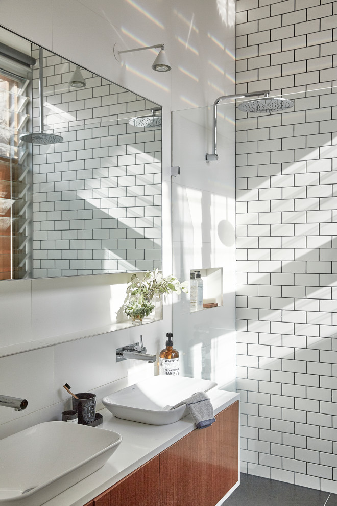 Small industrial master bathroom in Sydney with medium wood cabinets, engineered quartz benchtops, ceramic tile, ceramic floors, a vessel sink, grey floor, an open shower, white benchtops, flat-panel cabinets, an alcove shower and white tile.
