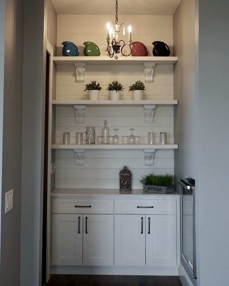 Example of a large transitional l-shaped medium tone wood floor kitchen pantry design in Cedar Rapids with an undermount sink, shaker cabinets, white cabinets, quartz countertops, multicolored backsplash, cement tile backsplash, stainless steel appliances and an island