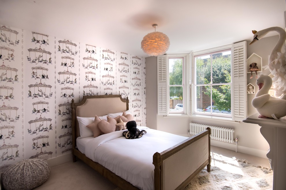 Photo of a mid-sized transitional kids' bedroom for kids 4-10 years old and girls in London with grey walls, carpet and beige floor.