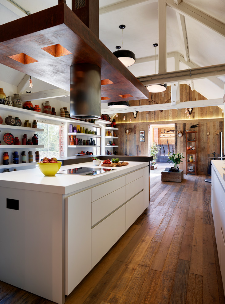 Inspiration for a mid-sized contemporary single-wall eat-in kitchen in Wiltshire with an integrated sink, flat-panel cabinets, white cabinets, laminate benchtops, white splashback, glass sheet splashback, stainless steel appliances, medium hardwood floors and with island.