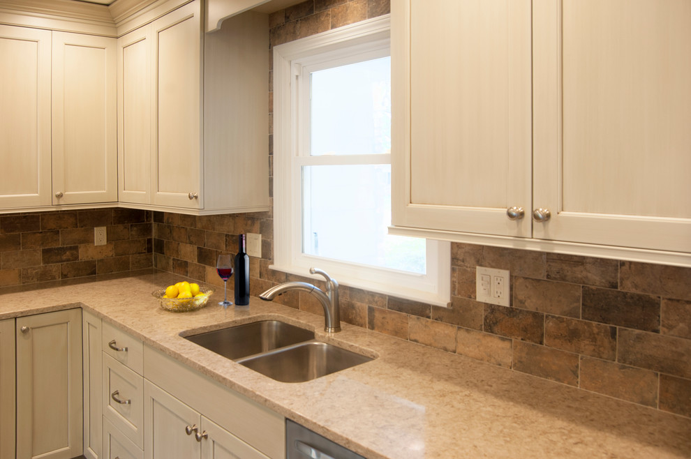 Mid-sized transitional l-shaped eat-in kitchen photo in Chicago with an undermount sink, recessed-panel cabinets, beige cabinets, quartz countertops, brown backsplash, porcelain backsplash, stainless steel appliances and no island