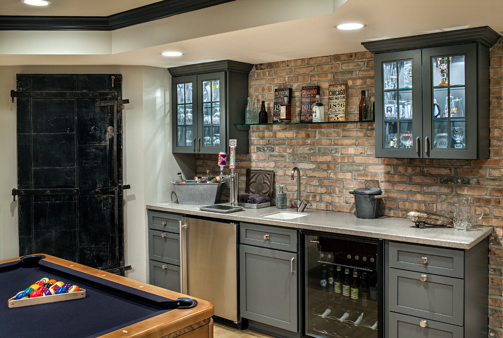 This is an example of a transitional single-wall wet bar in Chicago with shaker cabinets, blue cabinets, an undermount sink, red splashback and light hardwood floors.