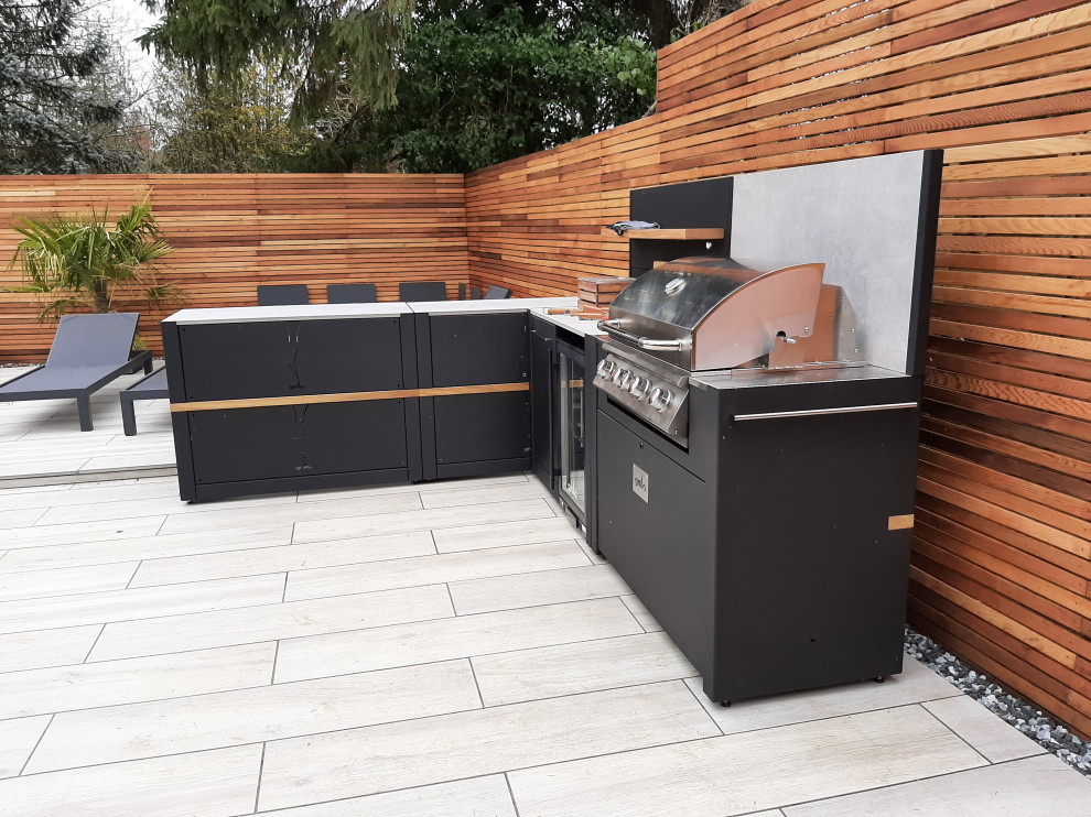 Photo of a small modern backyard patio in Berkshire with an outdoor kitchen, decking and no cover.