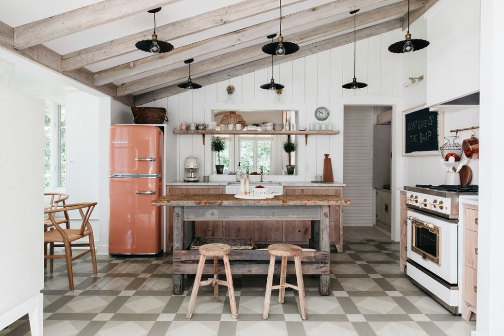 Beach style l-shaped kitchen in Grand Rapids with a farmhouse sink, flat-panel cabinets, light wood cabinets, coloured appliances, painted wood floors, with island, grey floor and white benchtop.