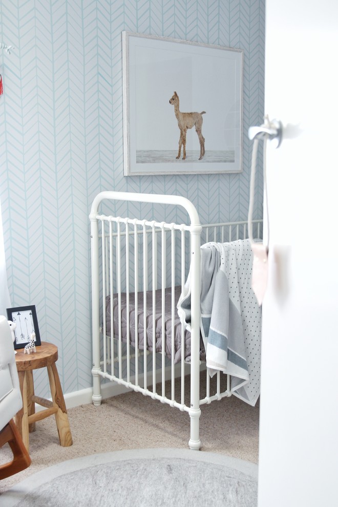 Inspiration for a small scandinavian gender-neutral nursery with blue walls, carpet and beige floor.