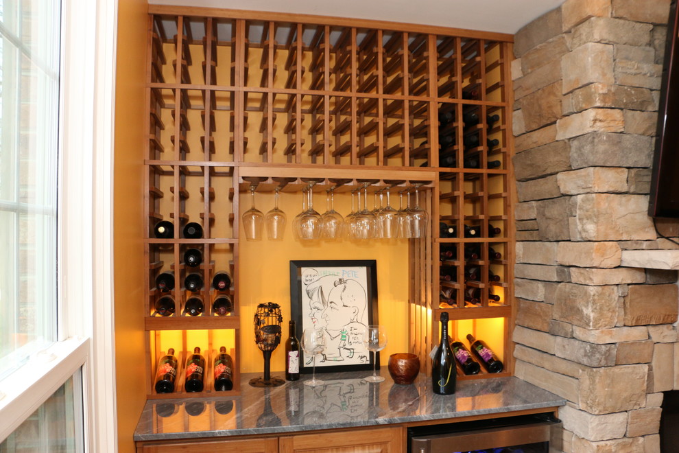 Small traditional wine cellar in Cincinnati with light hardwood floors and storage racks.