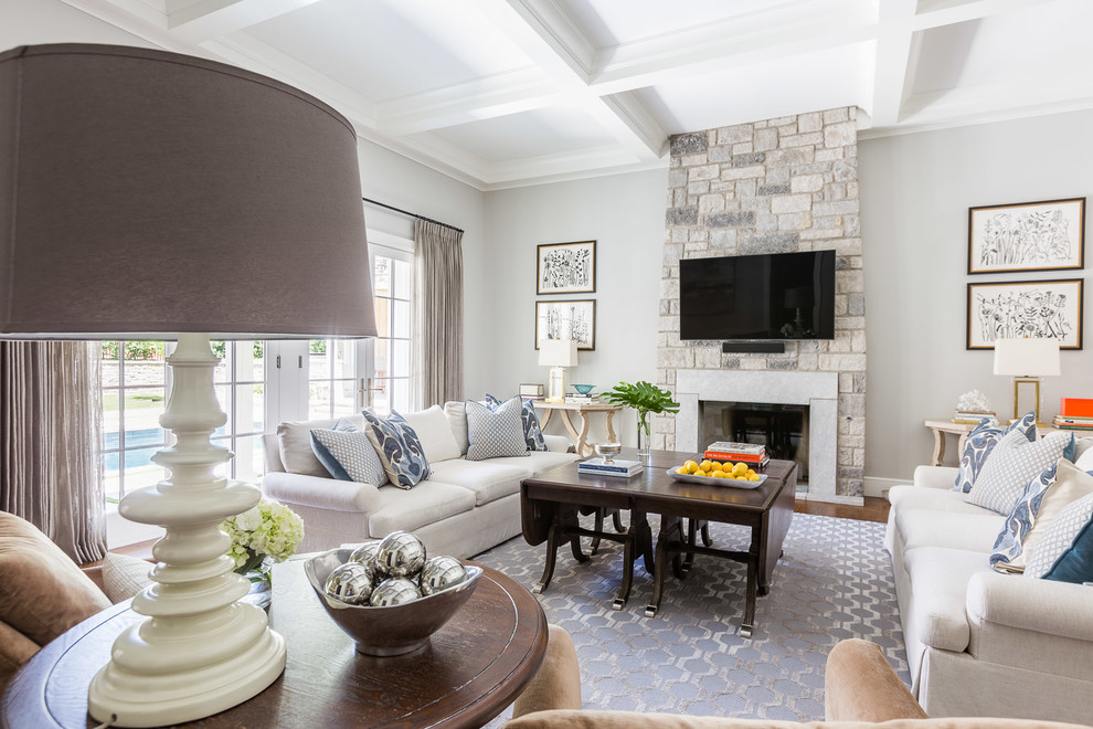 Large transitional open concept living room in Other with beige walls, medium hardwood floors, a standard fireplace and a brick fireplace surround.