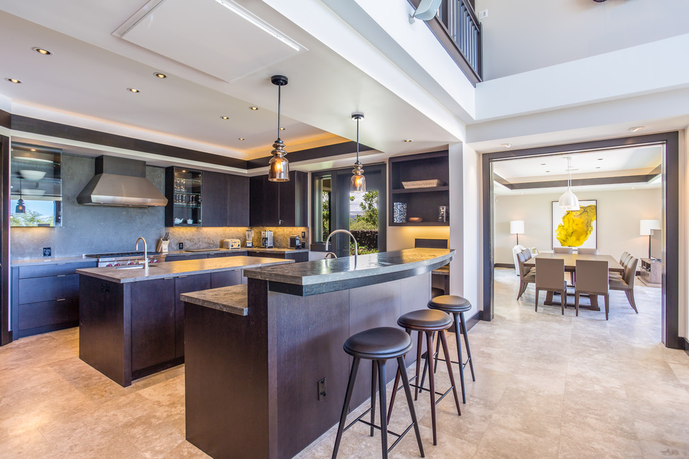 This is an example of a contemporary eat-in kitchen in Hawaii with an undermount sink, flat-panel cabinets, dark wood cabinets, soapstone benchtops, grey splashback, stone slab splashback, panelled appliances, marble floors and multiple islands.