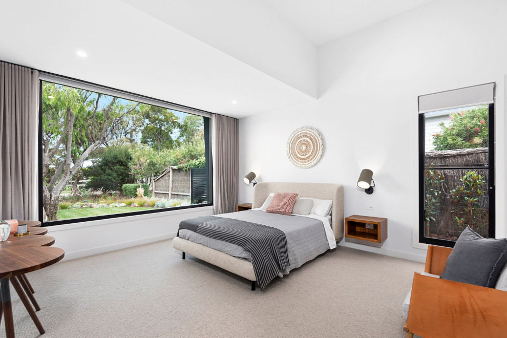 This is an example of a large contemporary master bedroom in Other with white walls, carpet and beige floor.