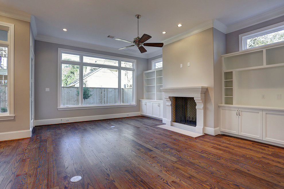 Photo of a mid-sized transitional enclosed family room in Houston with grey walls, dark hardwood floors, a standard fireplace, a concrete fireplace surround and brown floor.