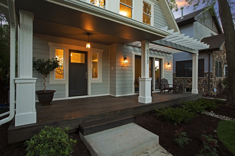 Photo of a transitional front yard verandah in Minneapolis with a pergola.