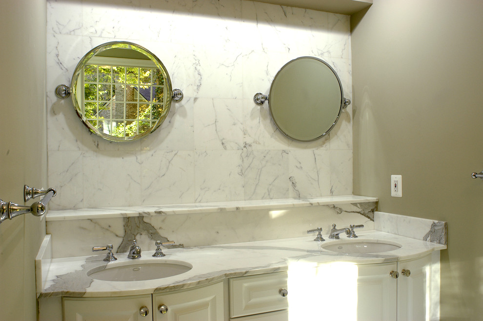 Photo of a mid-sized arts and crafts 3/4 bathroom in DC Metro with an undermount sink, raised-panel cabinets, white cabinets, marble benchtops, a freestanding tub, an open shower, a one-piece toilet, white tile, stone slab and beige walls.