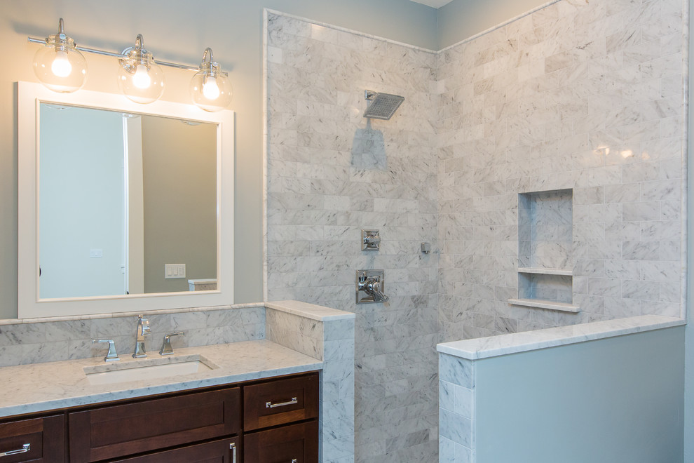 Corner shower - mid-sized transitional 3/4 white tile and subway tile marble floor and white floor corner shower idea in Seattle with shaker cabinets, medium tone wood cabinets, gray walls, an undermount sink, marble countertops and white countertops