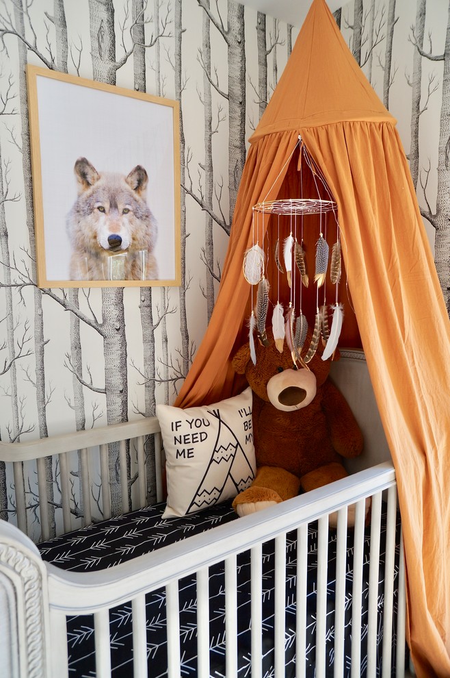 This is an example of an eclectic gender-neutral nursery in Los Angeles with multi-coloured walls.