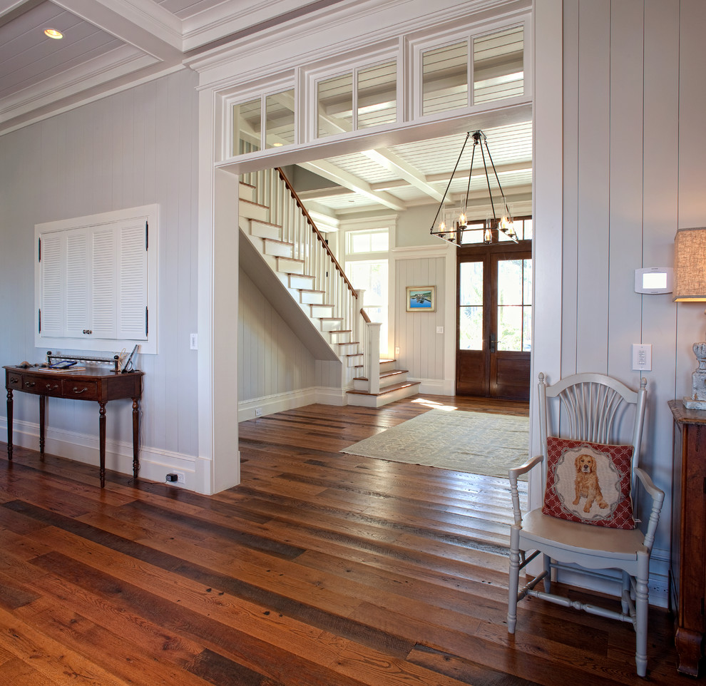 Inspiration for a large beach style foyer in Charleston with grey walls, medium hardwood floors, a single front door and a dark wood front door.