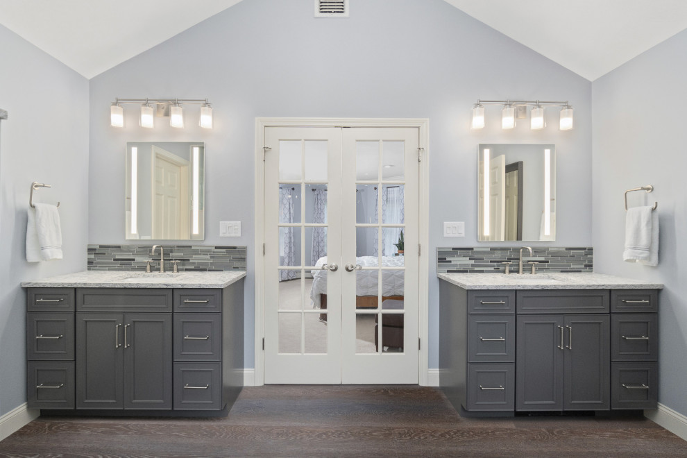This is an example of a large transitional master bathroom in Other with shaker cabinets, grey cabinets, a freestanding tub, a double shower, a two-piece toilet, blue tile, porcelain tile, blue walls, vinyl floors, an undermount sink, engineered quartz benchtops, grey floor, a hinged shower door, multi-coloured benchtops, a shower seat, a double vanity and a built-in vanity.