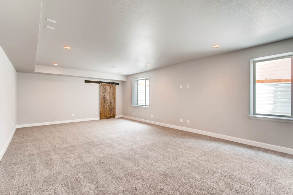 Example of a large underground carpeted and gray floor basement design in Denver with gray walls and no fireplace