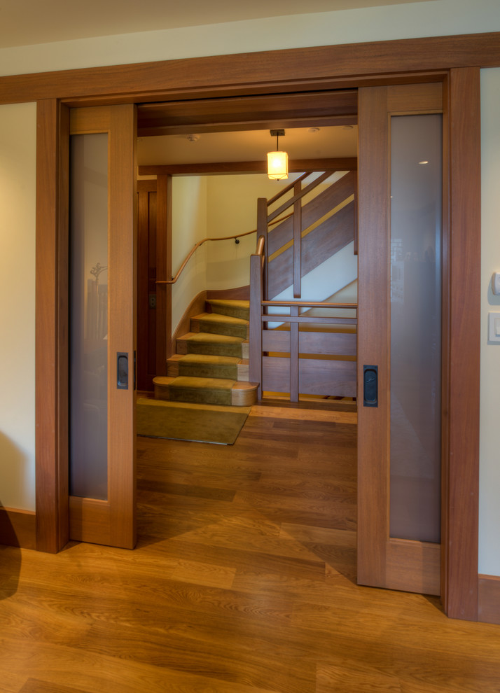 This is an example of a mid-sized arts and crafts wood staircase in San Francisco with wood risers.