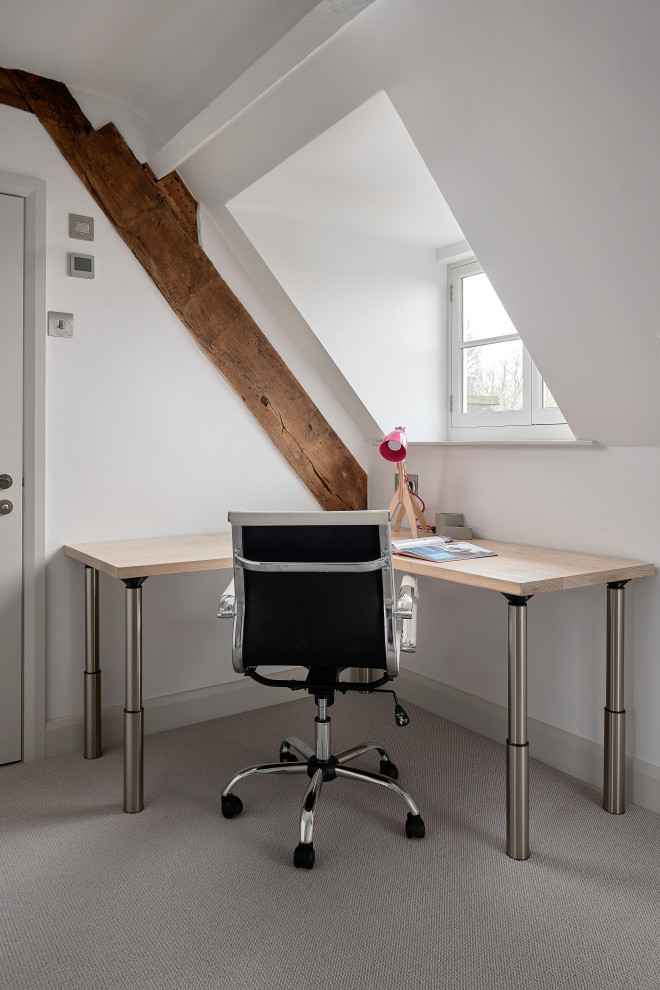 Small modern study room in Hampshire with white walls, carpet, a freestanding desk and beige floor.