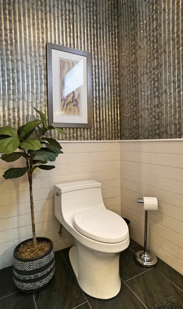 Photo of a mid-sized contemporary powder room in Toronto with shaker cabinets, white cabinets, a one-piece toilet, gray tile, porcelain tile, grey walls, porcelain floors, a vessel sink, engineered quartz benchtops, black floor, white benchtops, a built-in vanity and decorative wall panelling.