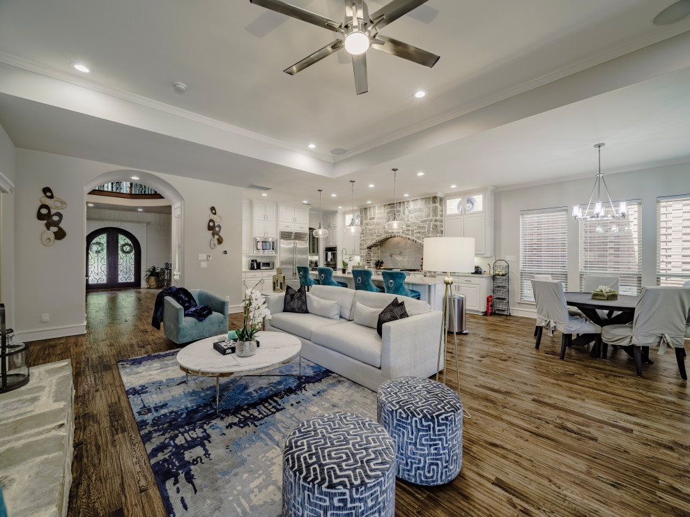 Large transitional formal open concept living room in Dallas with beige walls, dark hardwood floors, a standard fireplace, a built-in media wall, blue floor, coffered and brick walls.