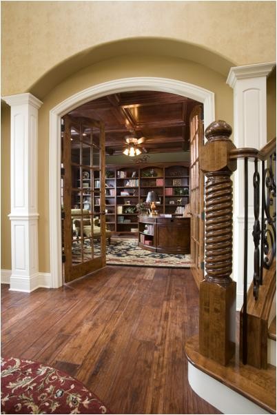 Large traditional home office in Chicago with a library, green walls, medium hardwood floors, no fireplace and a freestanding desk.