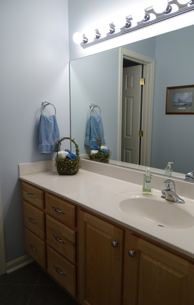 Small traditional 3/4 bathroom in Other with raised-panel cabinets, yellow cabinets, white tile, ceramic tile, blue walls, ceramic floors, an integrated sink and engineered quartz benchtops.