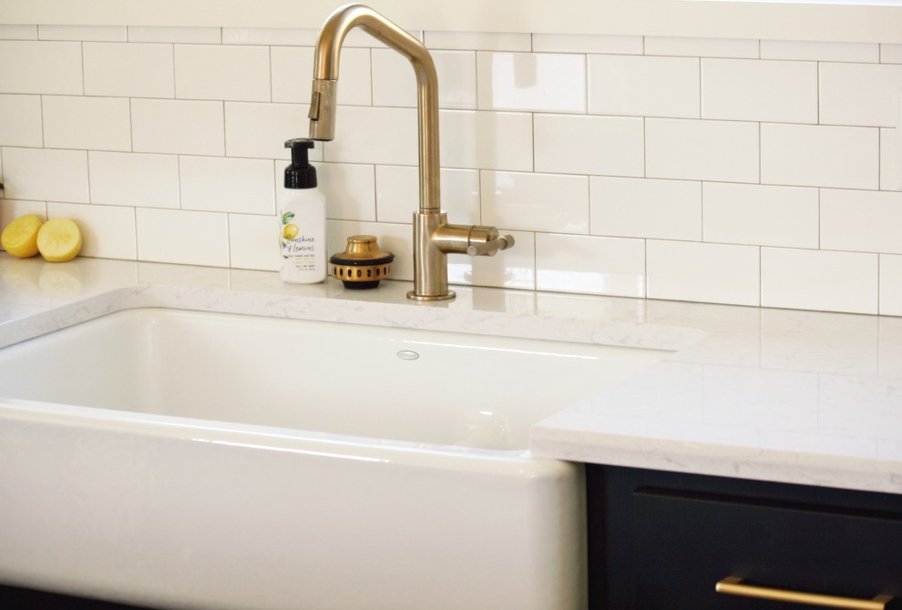 Inspiration for a transitional gray floor kitchen remodel with a farmhouse sink, quartz countertops and stainless steel appliances