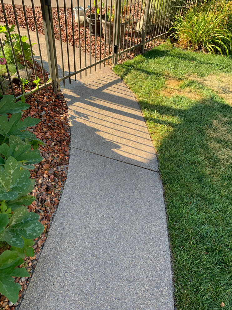 Photo of a backyard concrete landscaping.