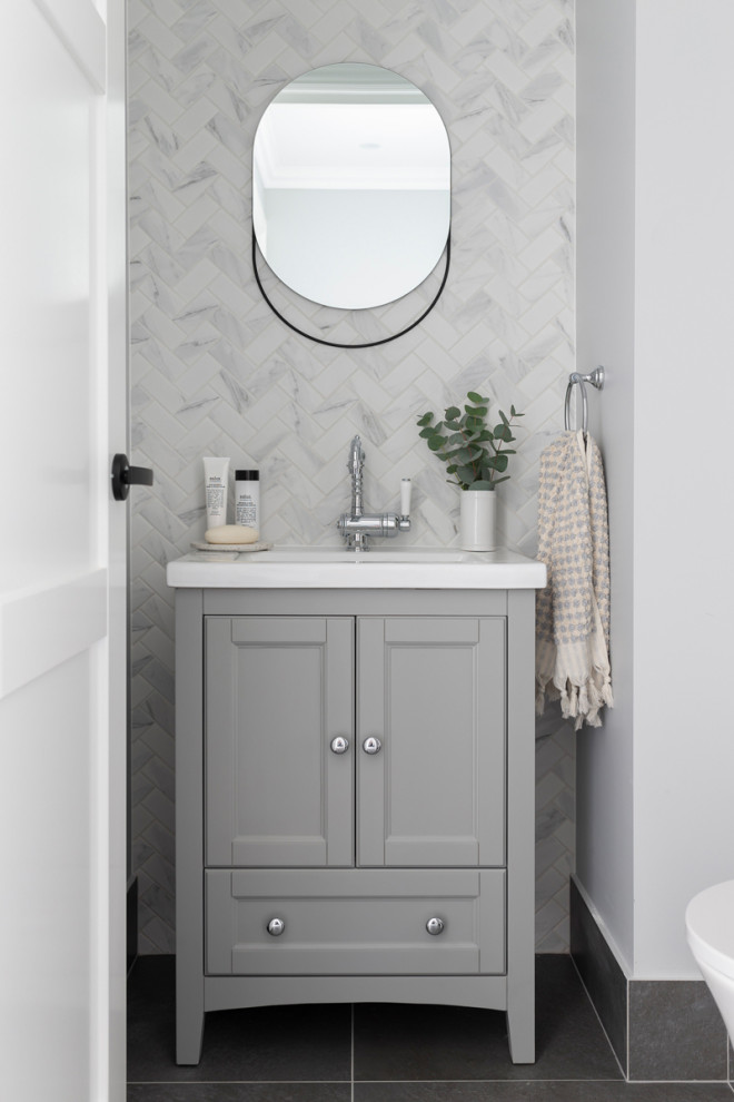 Design ideas for a small traditional powder room in Canberra - Queanbeyan with shaker cabinets, grey cabinets, a one-piece toilet, white tile, mosaic tile, grey walls, porcelain floors, an undermount sink, marble benchtops, grey floor, white benchtops and a freestanding vanity.