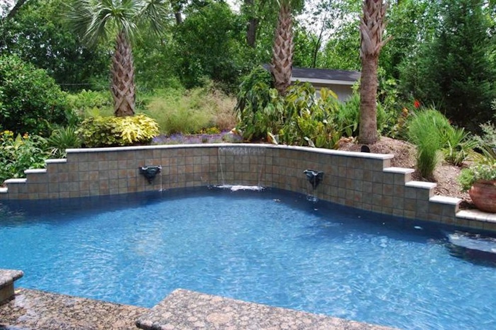 Mid-sized backyard stone and rectangular natural pool fountain photo