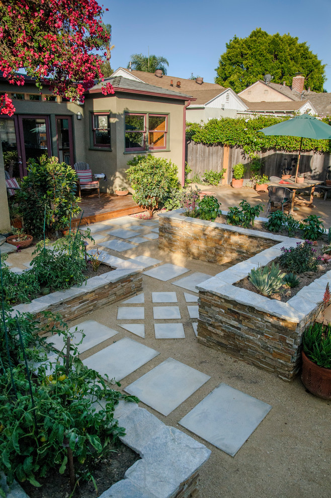 Photo of a mid-sized traditional partial sun backyard gravel vegetable garden landscape in Los Angeles.