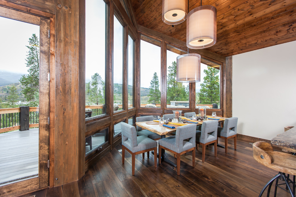 Country dining room in Denver with white walls and dark hardwood floors.