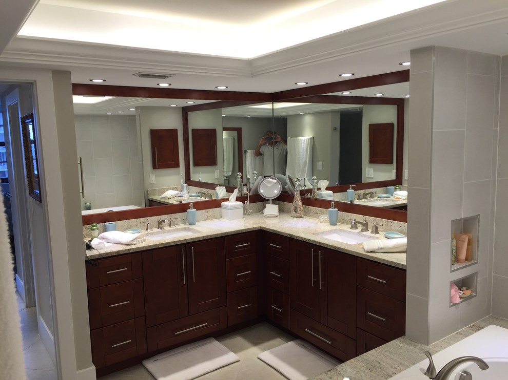Drop-in bathtub - mid-sized transitional master gray tile and porcelain tile gray floor drop-in bathtub idea in Miami with shaker cabinets, dark wood cabinets, gray walls, an undermount sink and granite countertops
