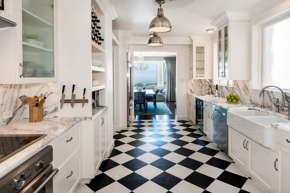 Design ideas for a mid-sized eclectic galley separate kitchen in San Francisco with a farmhouse sink, shaker cabinets, white cabinets, marble benchtops, grey splashback, marble splashback, stainless steel appliances, vinyl floors, no island, multi-coloured floor and grey benchtop.