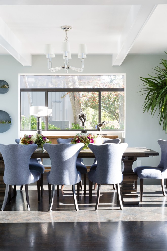 This is an example of a traditional dining room in San Francisco with blue walls and dark hardwood floors.