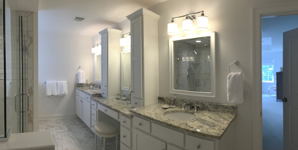Example of a large transitional master white tile and porcelain tile porcelain tile and white floor freestanding bathtub design with shaker cabinets, white cabinets, a one-piece toilet, white walls, an undermount sink, quartz countertops, a hinged shower door and white countertops
