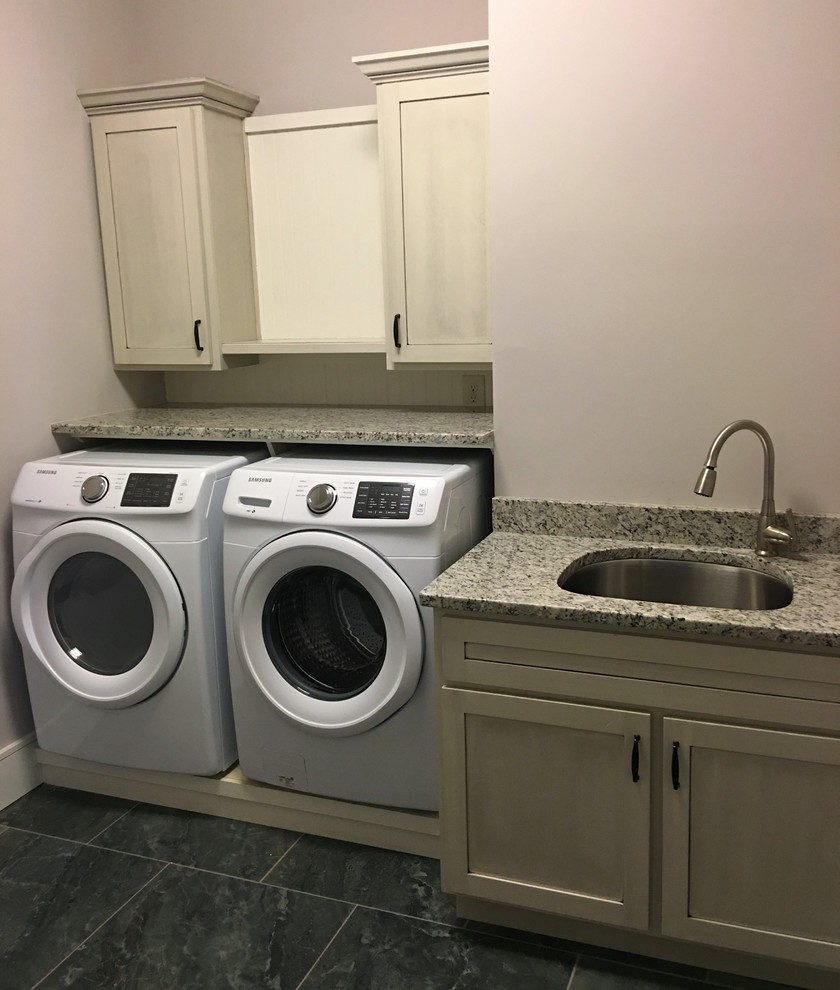 Mid-sized transitional single-wall dedicated laundry room in Atlanta with an undermount sink, shaker cabinets, beige cabinets, granite benchtops, grey walls, ceramic floors and a side-by-side washer and dryer.
