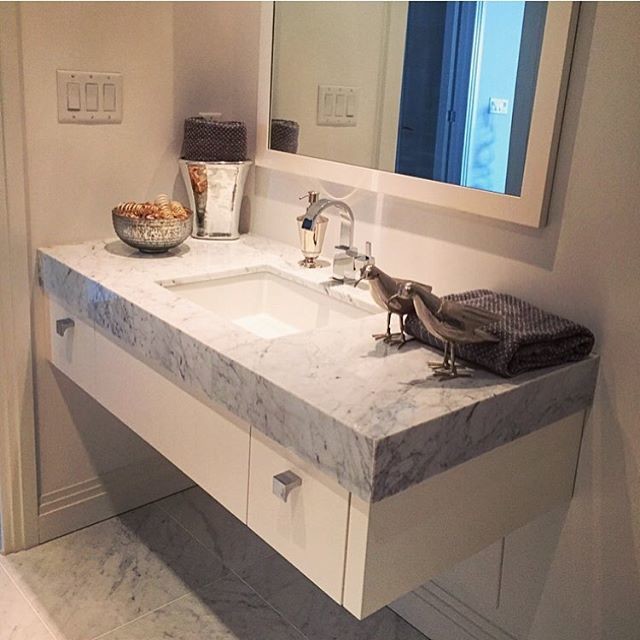Mid-sized transitional 3/4 marble floor bathroom photo in Toronto with flat-panel cabinets, white cabinets, white walls and marble countertops