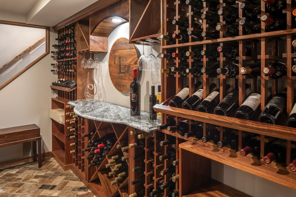 This is an example of a mid-sized traditional wine cellar in St Louis with porcelain floors, display racks and multi-coloured floor.