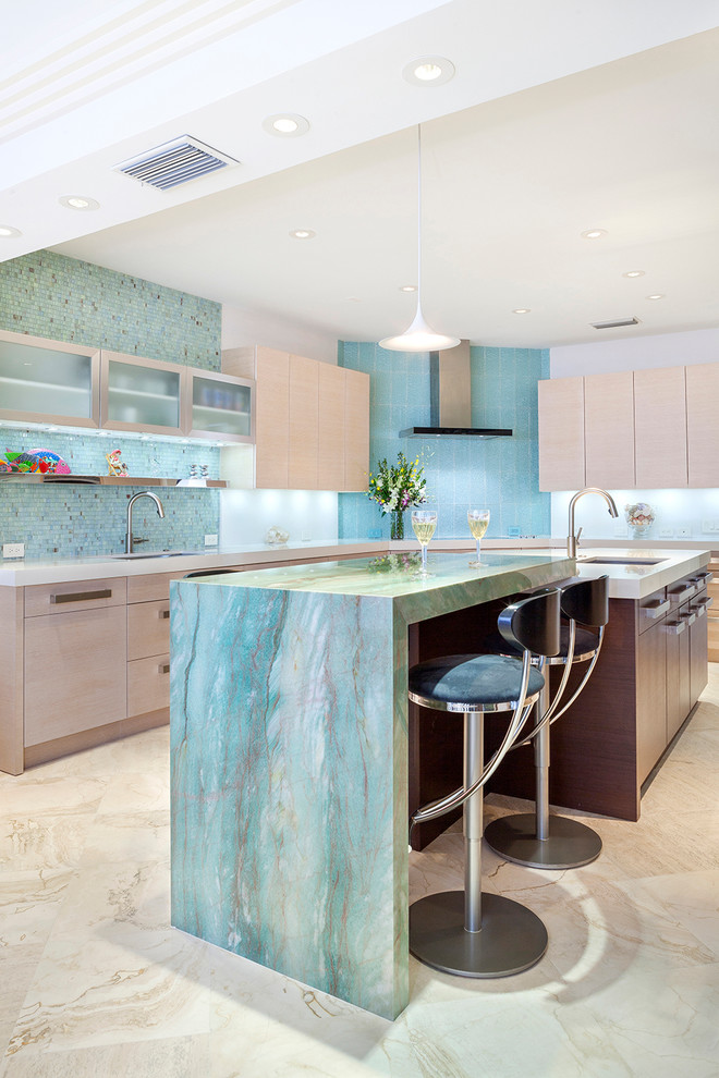This is an example of a large contemporary u-shaped eat-in kitchen in Miami with an undermount sink, flat-panel cabinets, light wood cabinets, granite benchtops, green splashback, glass sheet splashback, panelled appliances, marble floors, multiple islands, brown floor and green benchtop.