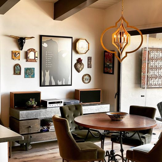 Mid-sized eclectic open plan dining in Orange County with vinyl floors, brown floor and exposed beam.