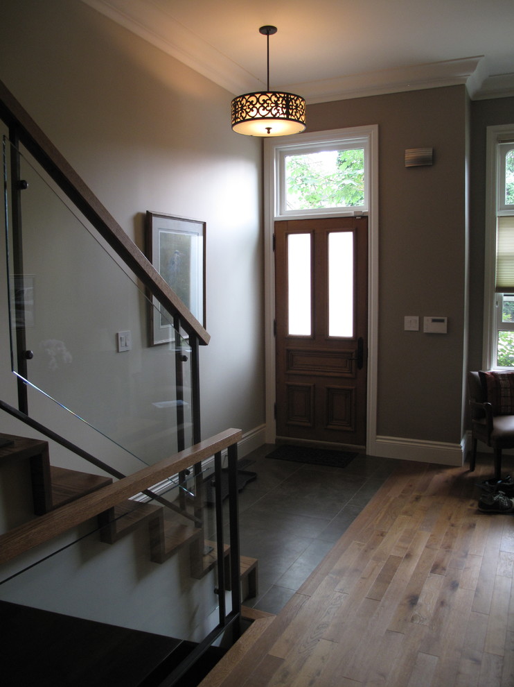 Example of a mid-sized transitional ceramic tile single front door design in Toronto with gray walls and a brown front door