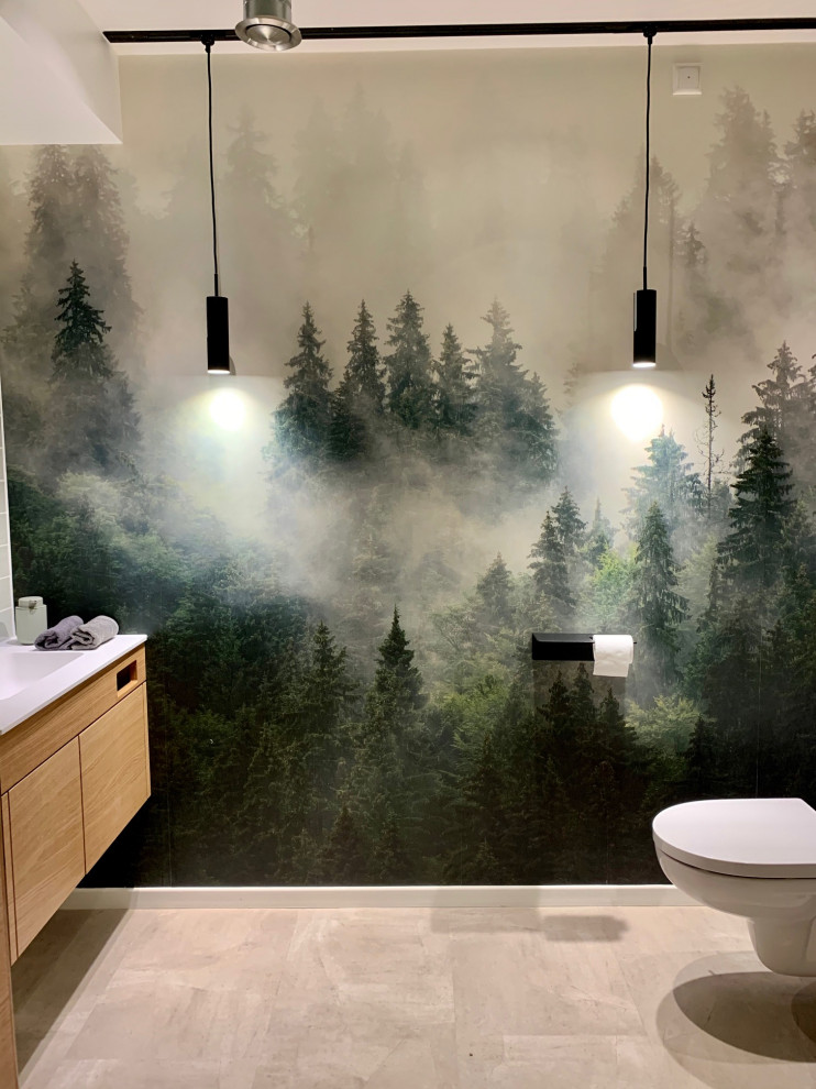 Photo of a small contemporary powder room in Munich with flat-panel cabinets, beige cabinets, green tile, ceramic tile, grey walls, concrete floors, a drop-in sink, wood benchtops, grey floor, a built-in vanity and wallpaper.